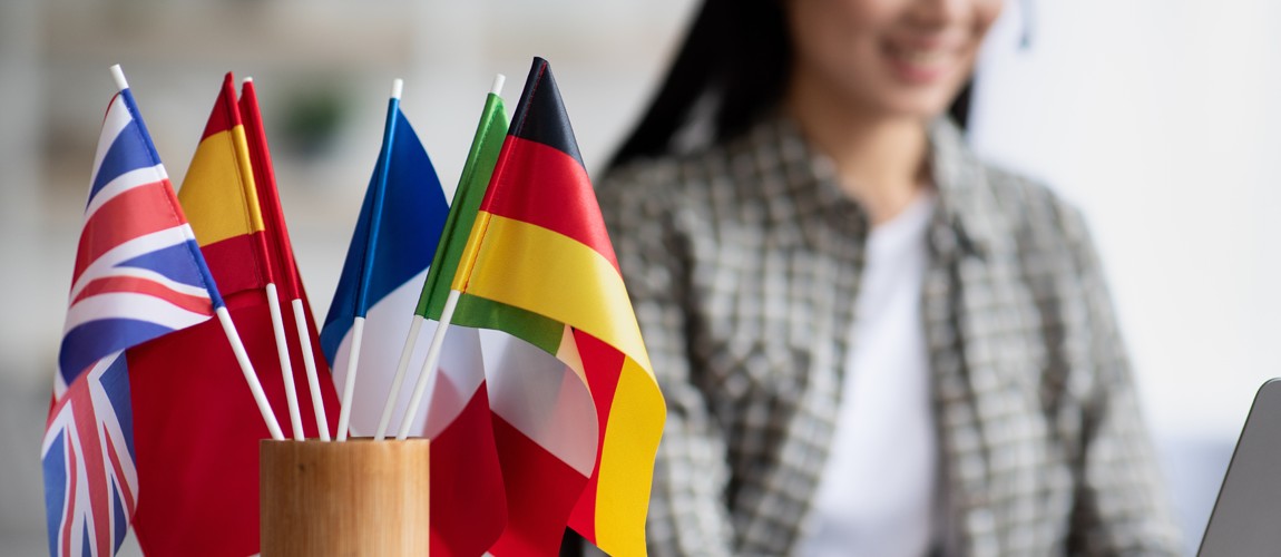 Close-up of teacher's desk with flags of many countries