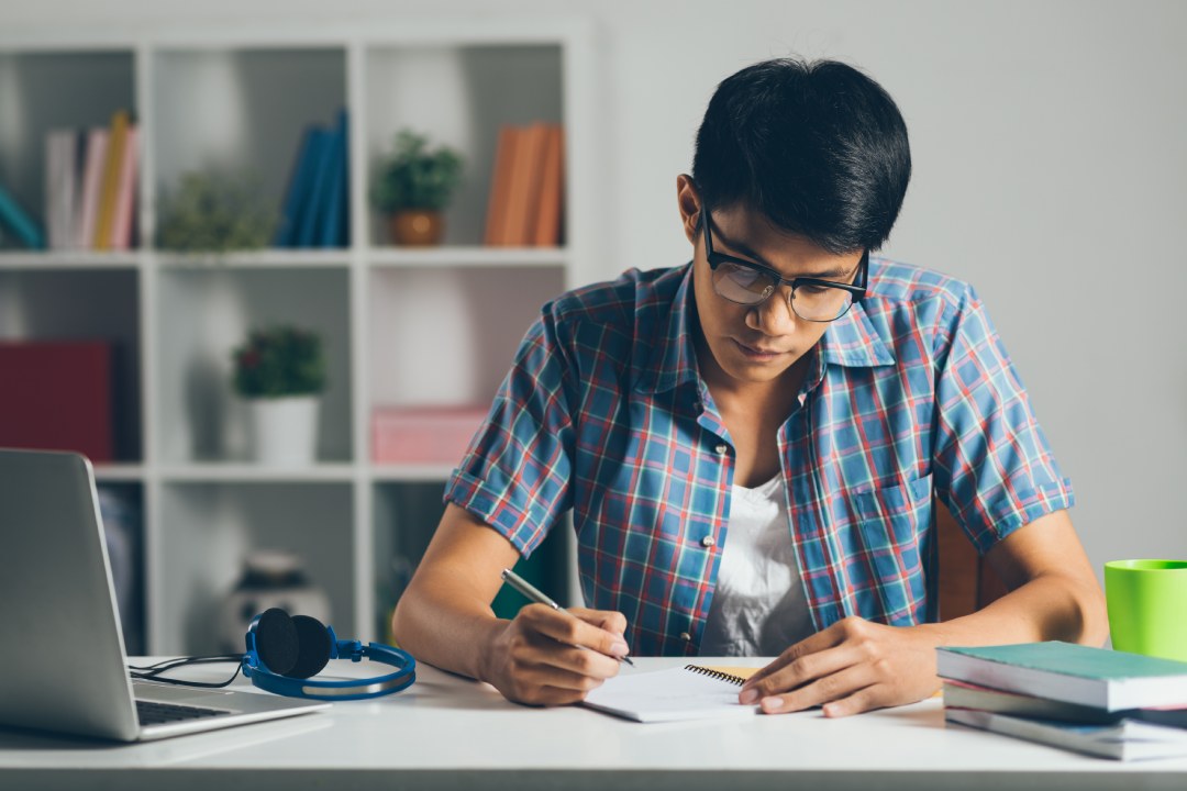 College student doing homework at home