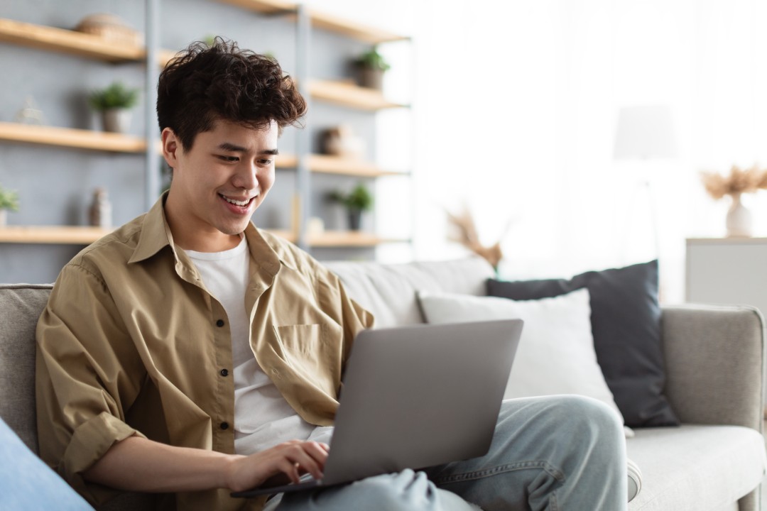 Man Sitting On The Couch Working On Pc Laptop