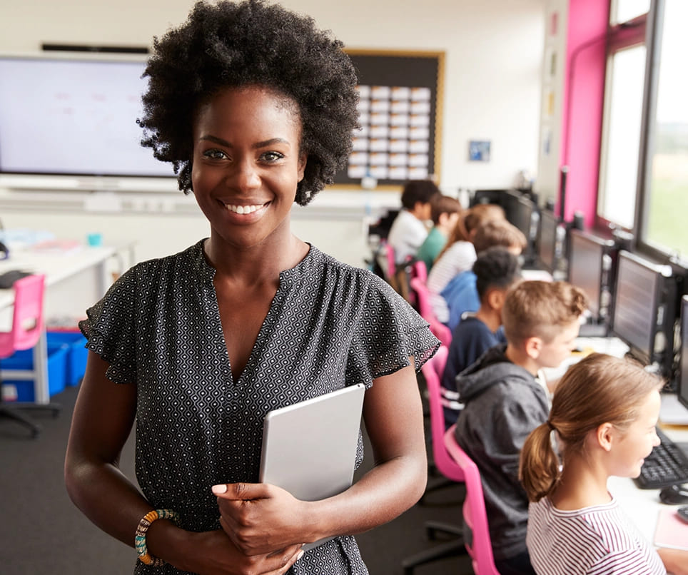 Black woman teacher smiling at classroom. 