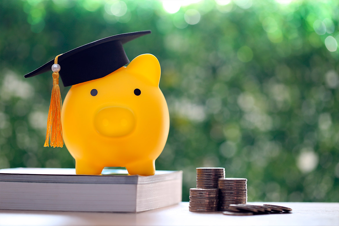 piggy bank with graduate hat and coins.