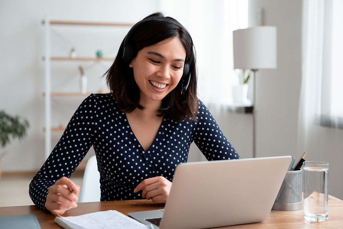 woman in front of laptop smiling 