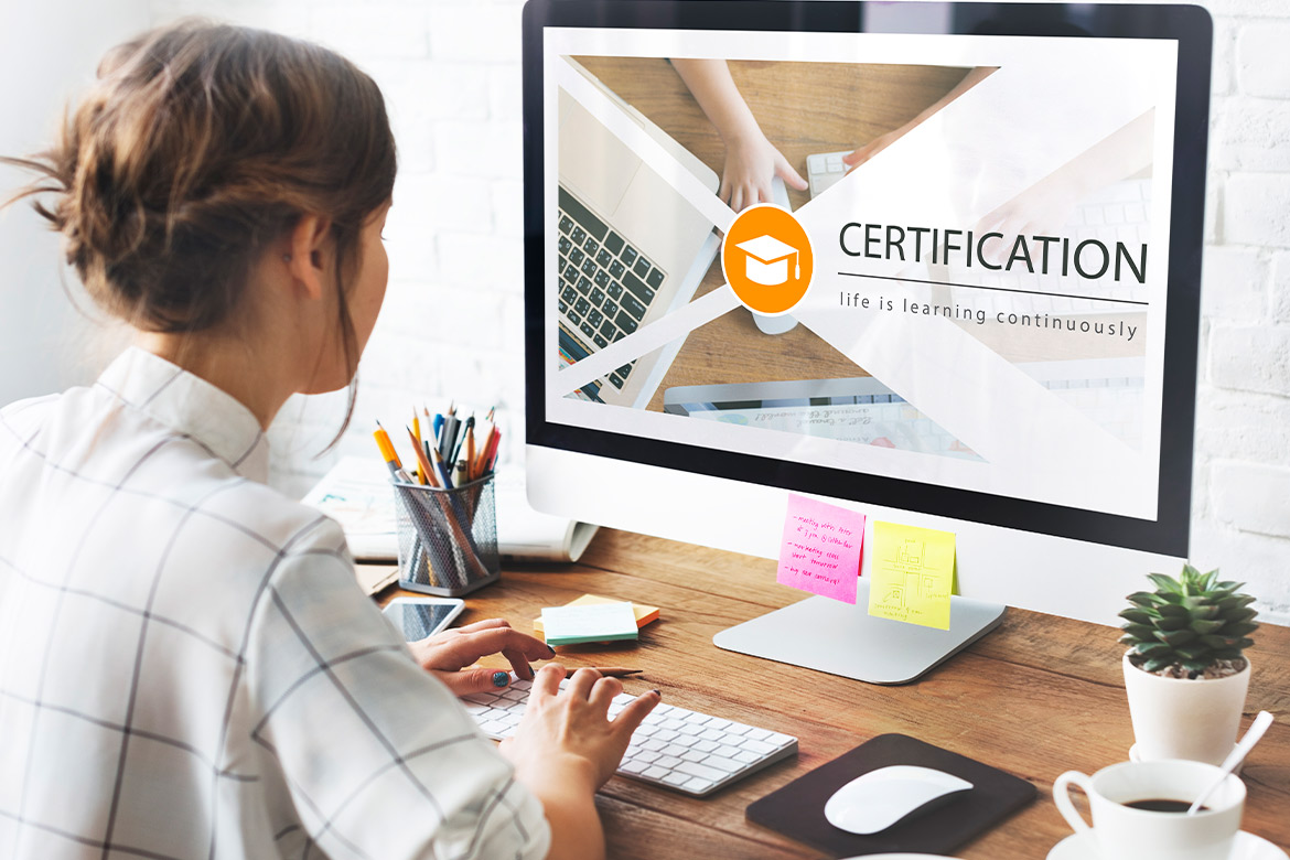 A woman is focused on her computer, displaying a Texas Teacher Certification guide 
