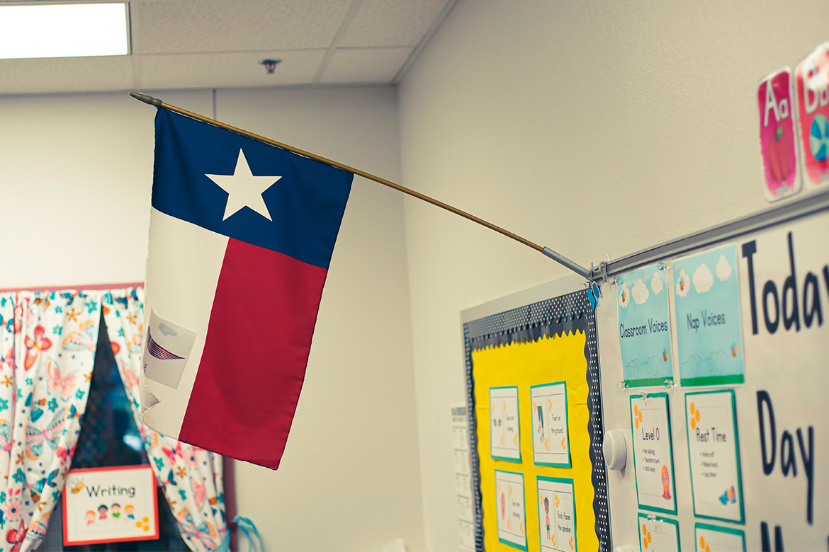 A classroom wall displaying a flag, symbolizing patriotism and the educational environment for aspiring teachers in Lubbock.