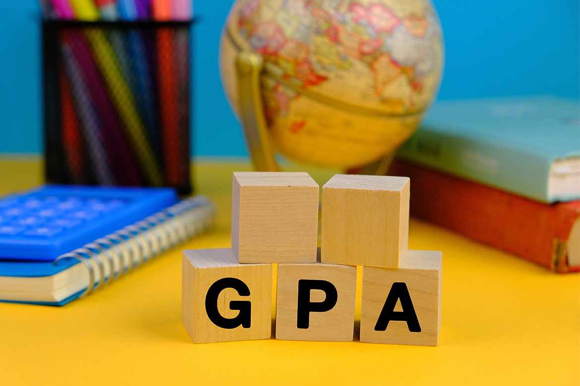 Graduation cap, laptop, and diploma arranged on concrete, symbolizing education and career transition in Texas.