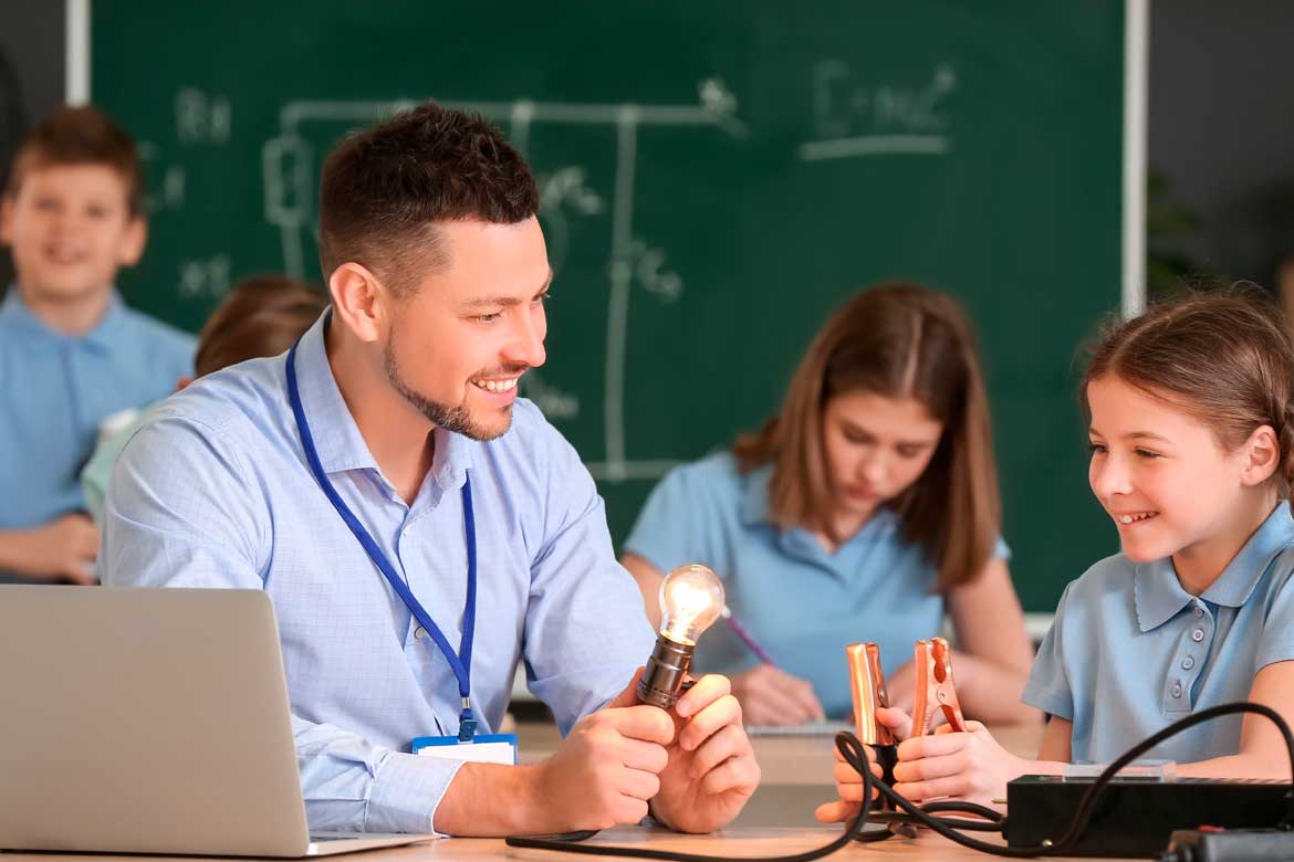 Teacher conducting physics lesson in classroom